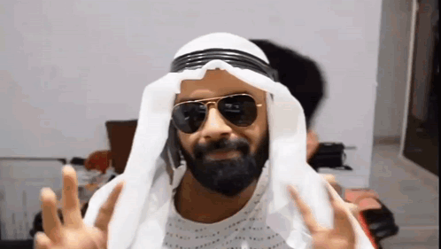 Man with Beard Sunglasses White Turban Making Peace Sign