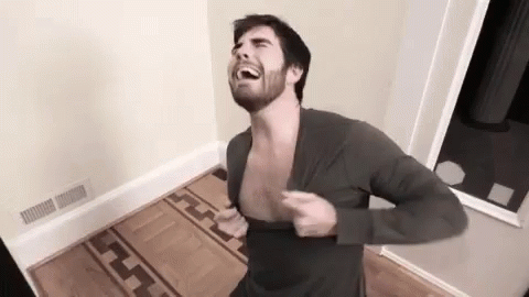Man with Beard Taking Off Shirt