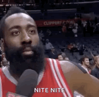 Man With Beard Talking Into Microphone In Stadium GIF