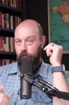 Man with Beard Talking Into Microphone