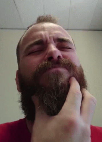 Man with Beard Touching Face