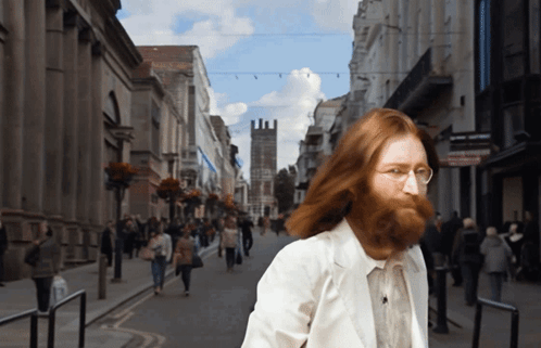 Man With Beard Walking Down Street GIF