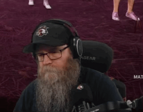 Man with Beard Wearing Eagles Hat and Headphones