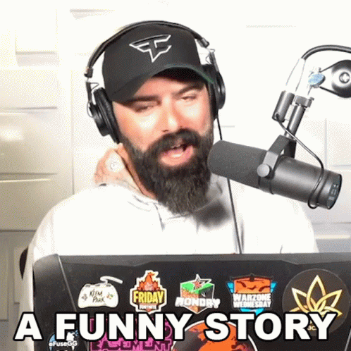 Man With Beard Wearing Headphones and Hat Says Funny Story