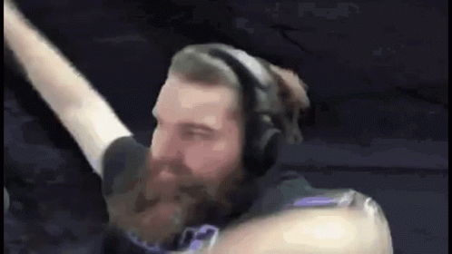 Man With Beard Wearing Headphones Holding Microphone