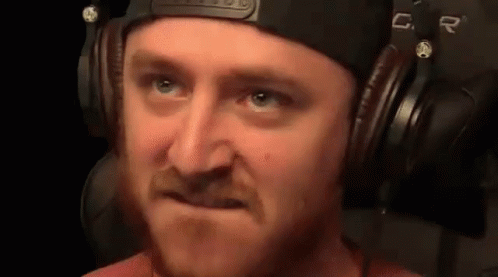 Man with Beard Wearing Headphones Making Face