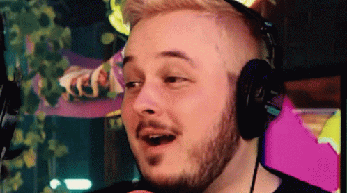 Man with Beard Wearing Headphones Making Face