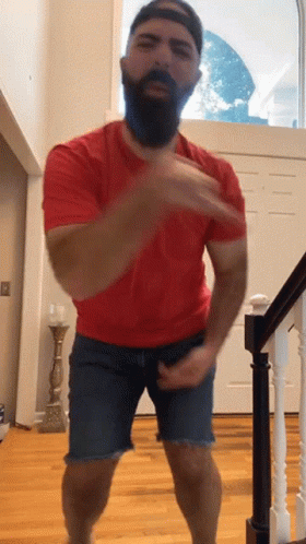 Man With Beard Wearing Red Shirt and Blue Shorts