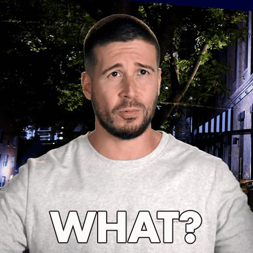 Man with Beard Wearing White Shirt Saying What