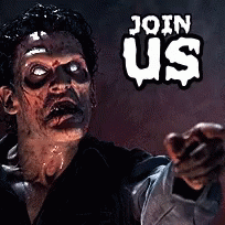 Man With Black Paint on Face in Front of Crowd