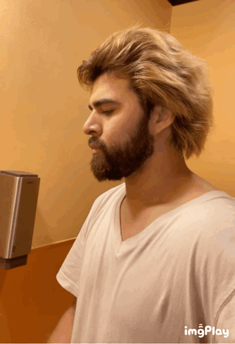 Man with Blonde Hair Taking Bathroom Selfie