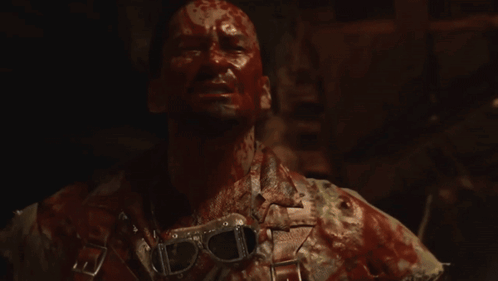 Man with Blood on Face Holding Hammer