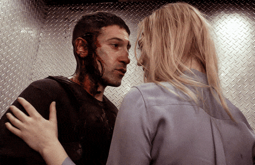 Man With Blood on Face Hugged by Blonde Woman