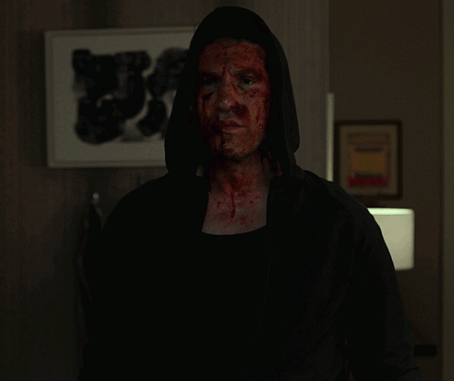 Man with Blood on Face in Black Hoodie