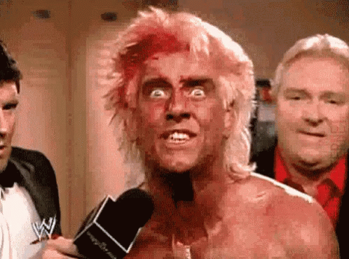 Man with Blood on Face Talking Into Microphone
