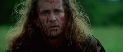 Man With Blood On His Face Standing In Field GIF