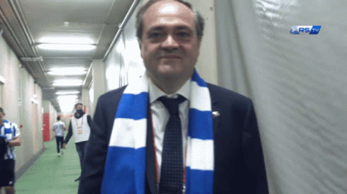 Man with Blue and White Scarf in Hallway RS Sign