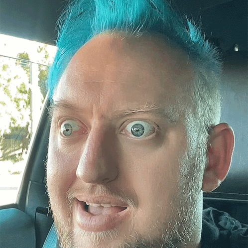 Man With Blue Hair Making Funny Face in Car