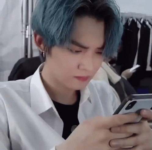 Man With Blue Hair Using Cell Phone