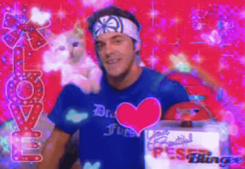 Man With Blue Heart Shirt Holding Stuffed Animal GIF