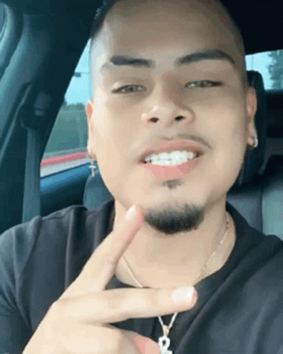 Man With Braces Peace Sign in Back Seat