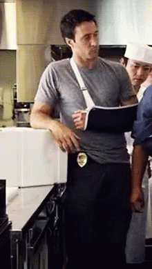 Man With Broken Arm In Cast In Kitchen
