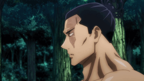 Man with Bun Standing in Forest