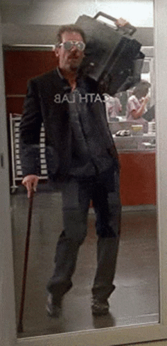 Man with Cane Carrying Suitcase and Bathta