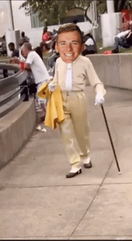 Man With Cane Walking Down Sidewalk