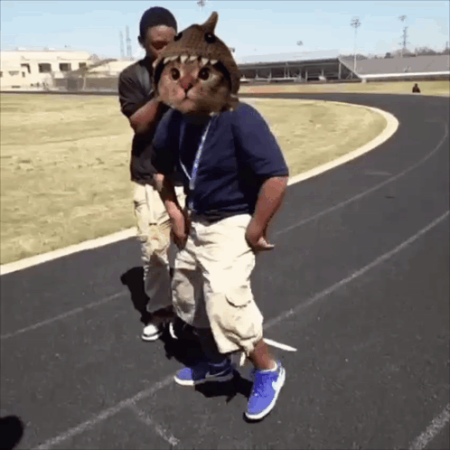 Man with Cat on Head Next to Man on Track