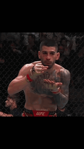 Man With Chest Tattoo And UFC Glove GIF