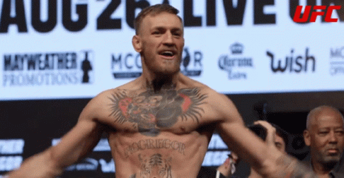 Man with Chest Tattoo and UFC Sign