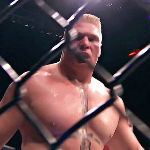 Man With Chest Tattoo Behind Cage GIF