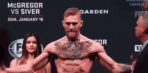 Man with Chest Tattoo in Front of McGregor vs Silver Sign
