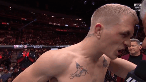 Man With Chest Tattoo In Front Of UFC Ring GIF