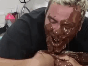 Man with Chocolate Face Eating Cake