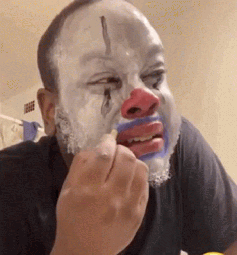 Man With Clown Face Eating Food