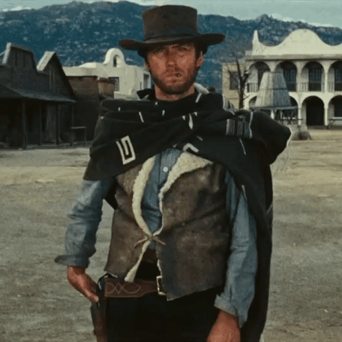 Man with Cowboy Hat Cape and D Vest