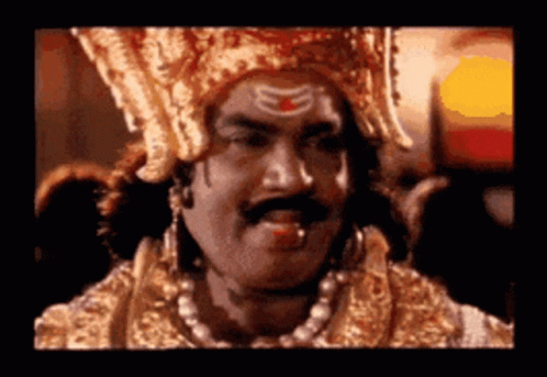 Man With Crown And Mustache Looking At Camera GIF