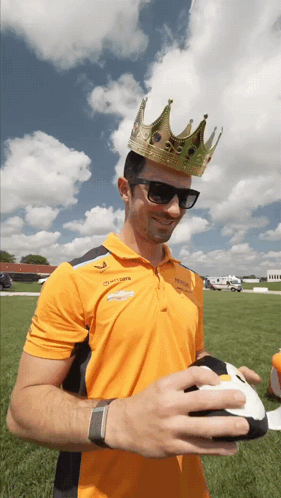 Man With Crown And Sunglasses Holding Football GIF
