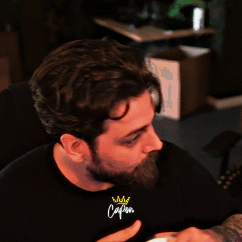 Man With Crown On Wrist Wearing Capon T-Shirt GIF