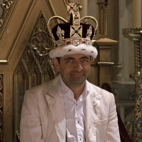 Man with Crown Sitting in Chair