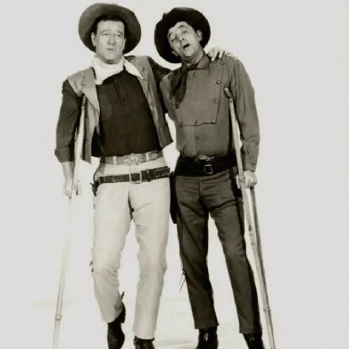 Man With Crutches Next to Man