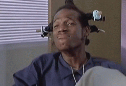 Man With Curlers Sitting by Blinds