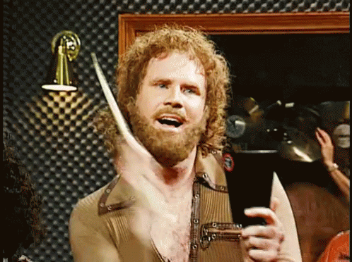 Man With Curly Hair and Beard Holding Drum Stick