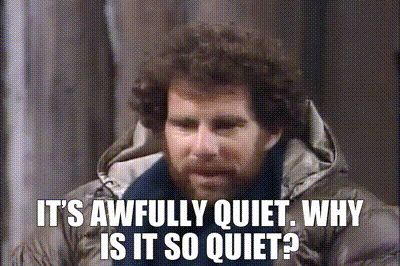 Man with Curly Hair and Beard Saying It's Quiet