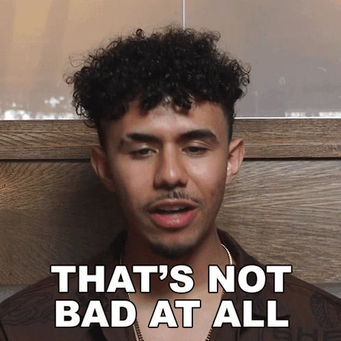 Man with Curly Hair and Beard Saying Not Bad
