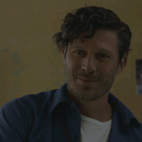 Man with Curly Hair and Beard Smiling