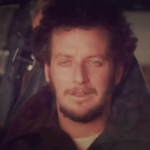 Man with Curly Hair and Beard Smiling