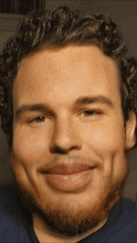 Man With Curly Hair and Beard Smiling